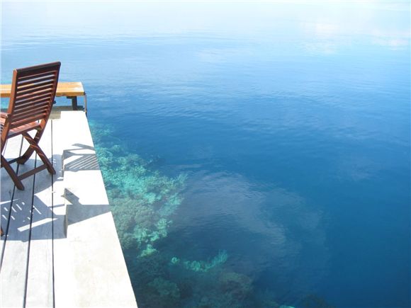 The reef visible at the end of the resort's dock.