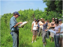 Participants listen to foresters at the Conference's Field Day to Howell Woods